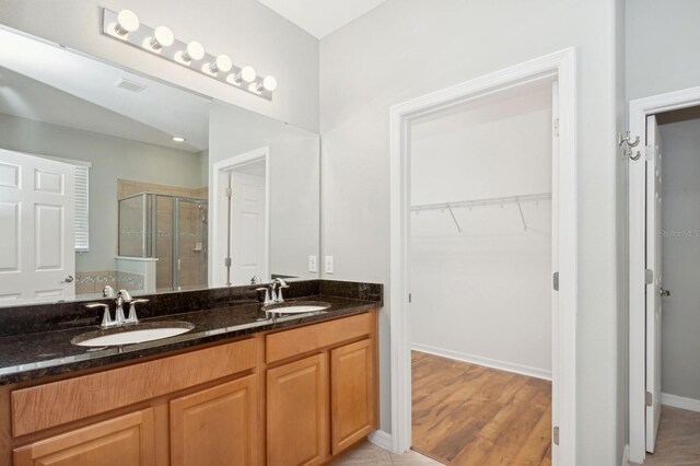 981 Galway Blvd, Apopka, FL 32703 - full bath with double vanity, a sink, a stall shower, and a walk in closet