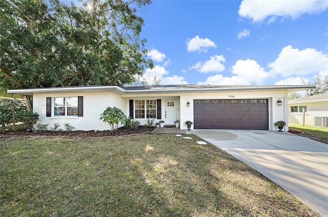 ranch-style home with a garage and a front yard