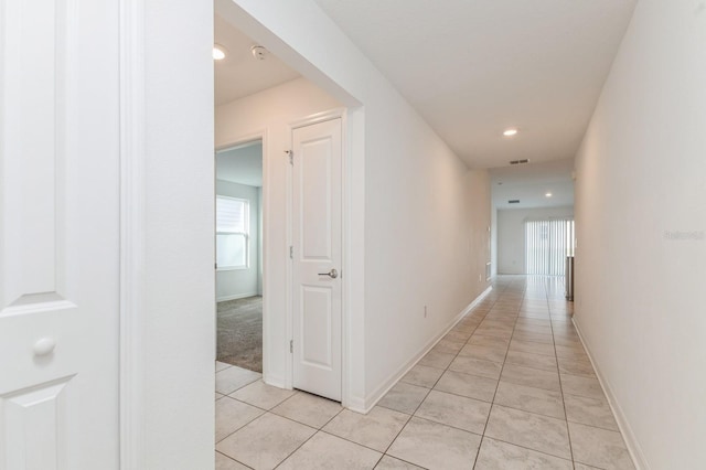 hall featuring light tile patterned flooring