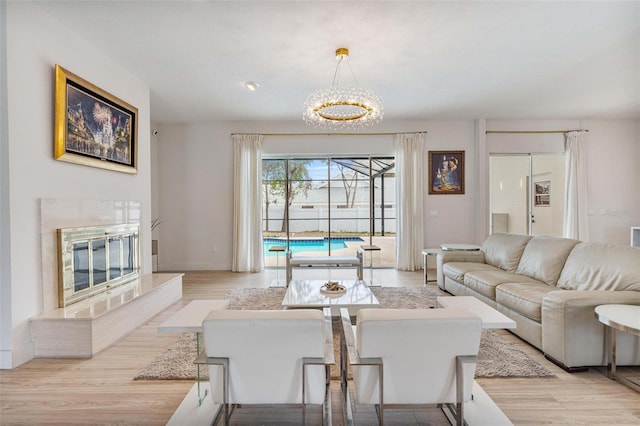 living room featuring a premium fireplace and light hardwood / wood-style flooring