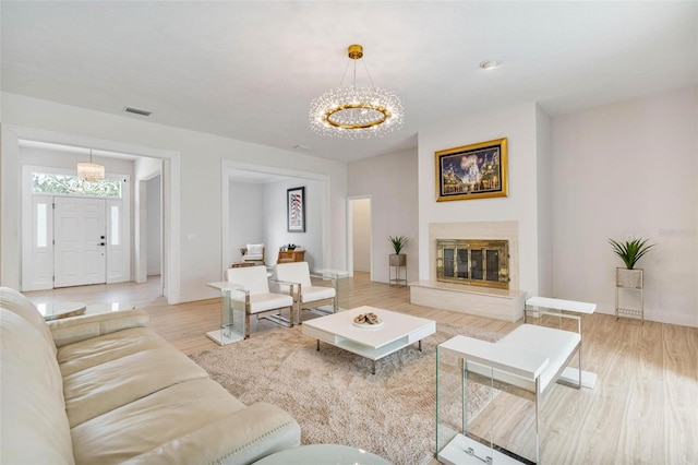 living room with wood-type flooring and a chandelier