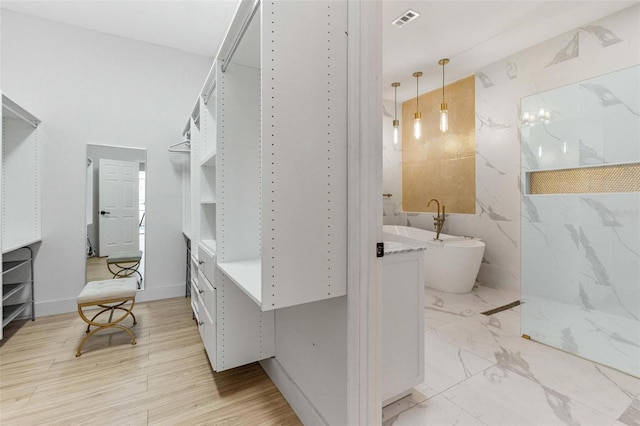 bathroom with plus walk in shower and hardwood / wood-style floors