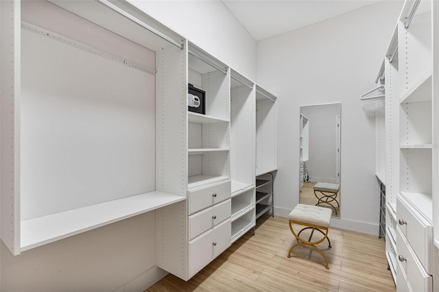 spacious closet featuring light hardwood / wood-style floors