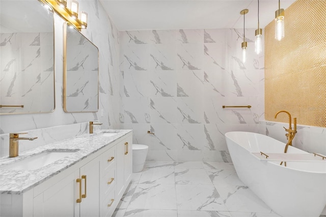 bathroom with tile walls, vanity, a bathtub, and toilet