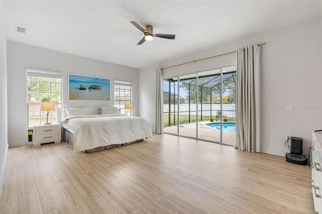 bedroom featuring multiple windows, ceiling fan, access to outside, and light wood-type flooring