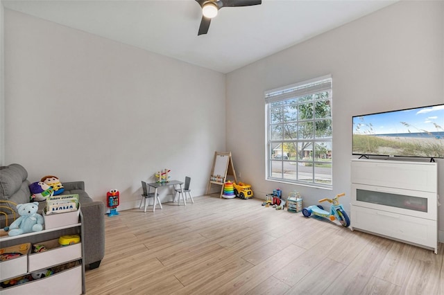 recreation room featuring ceiling fan and light hardwood / wood-style floors