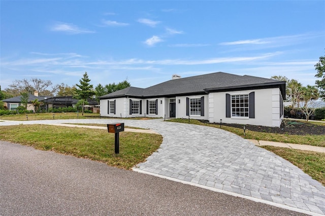 single story home featuring a lanai and a front lawn