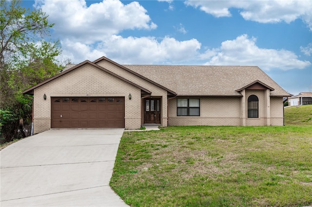 ranch-style home with a garage, brick siding, driveway, and a front yard