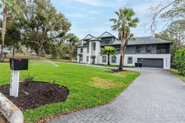 view of front of home featuring a front yard and a garage