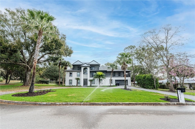 view of front facade with a front yard and a garage