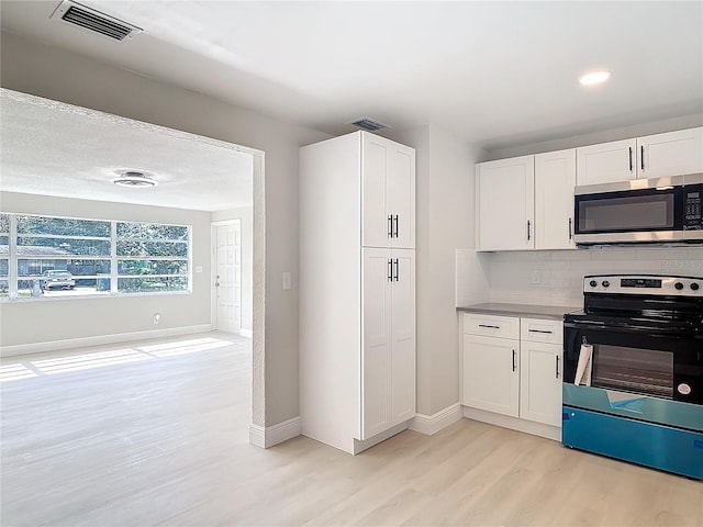 kitchen featuring tasteful backsplash, light hardwood / wood-style flooring, stainless steel appliances, and white cabinets