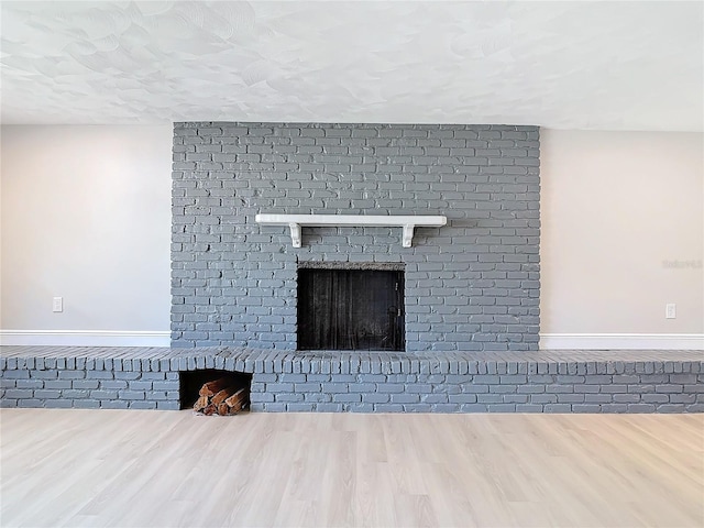 details featuring a brick fireplace and wood-type flooring