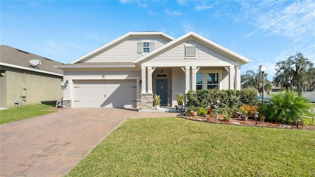 craftsman house featuring a garage and a front yard