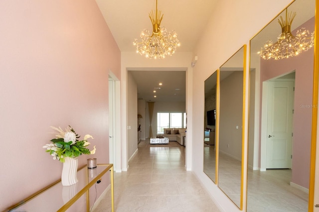 corridor with baseboards, recessed lighting, light tile patterned flooring, and an inviting chandelier