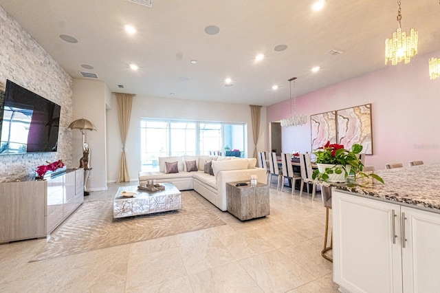 living room with visible vents, a notable chandelier, and recessed lighting