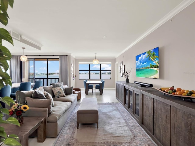 living area with ornamental molding, a water view, and light tile patterned flooring