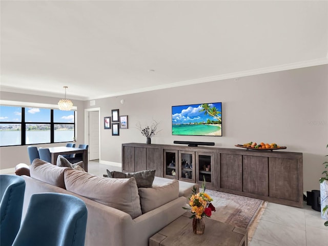 living area featuring baseboards, ornamental molding, and a chandelier