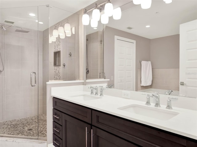 bathroom featuring a sink, recessed lighting, double vanity, and a shower stall