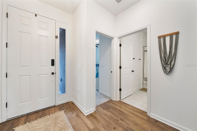 entryway featuring light wood-style floors and baseboards