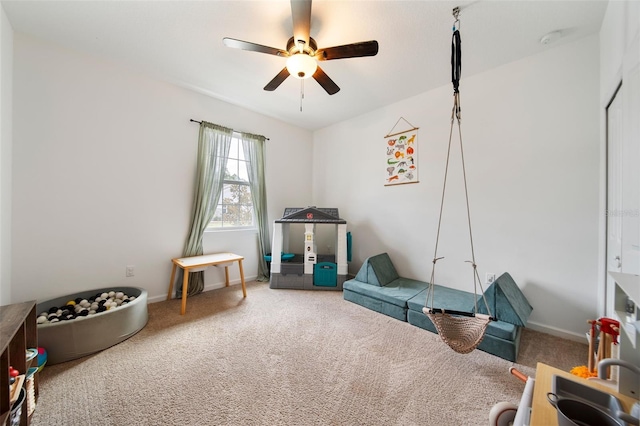 game room featuring ceiling fan, baseboards, and carpet flooring