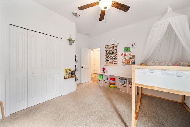 bedroom with light carpet, ceiling fan, a closet, and visible vents