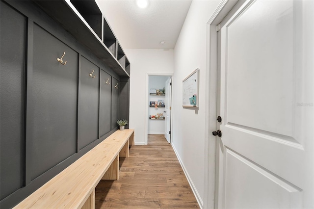 mudroom with baseboards and wood finished floors