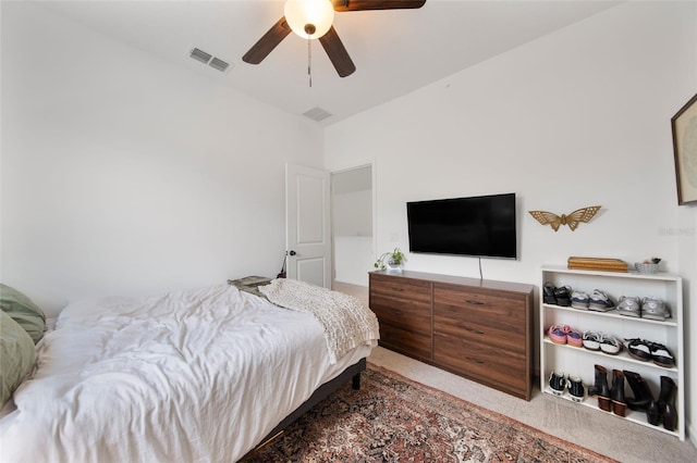 carpeted bedroom with visible vents and a ceiling fan