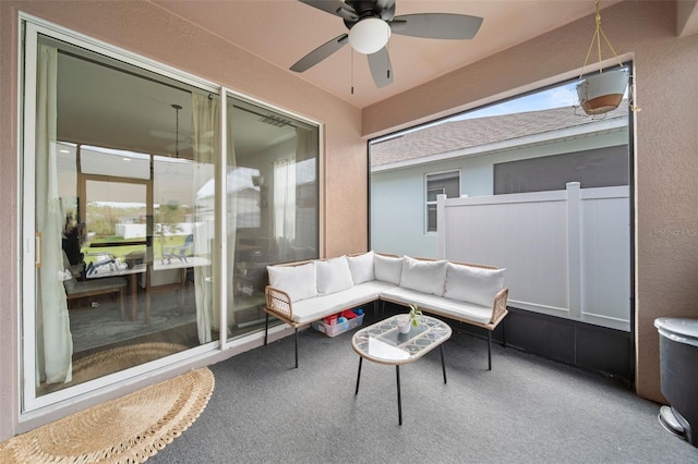 sunroom featuring a ceiling fan