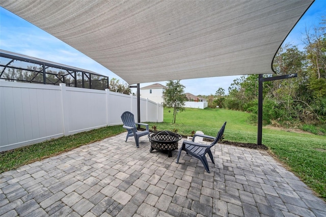 view of patio featuring an outdoor fire pit and fence