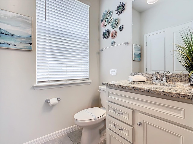 bathroom with tile patterned floors, vanity, and toilet