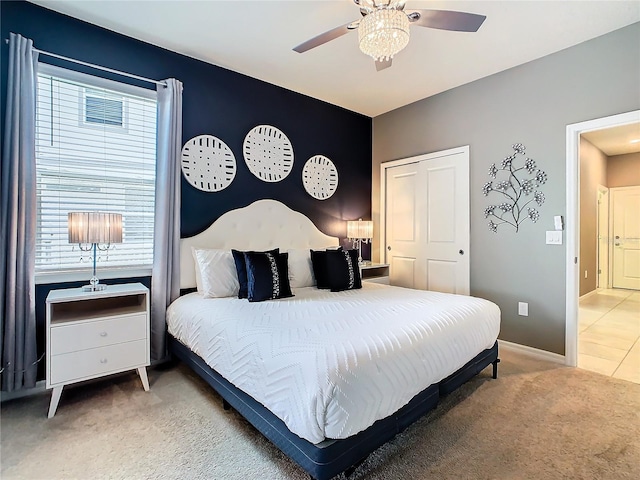 carpeted bedroom with multiple windows and ceiling fan