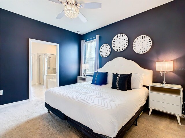 bedroom with light carpet, ensuite bath, and ceiling fan