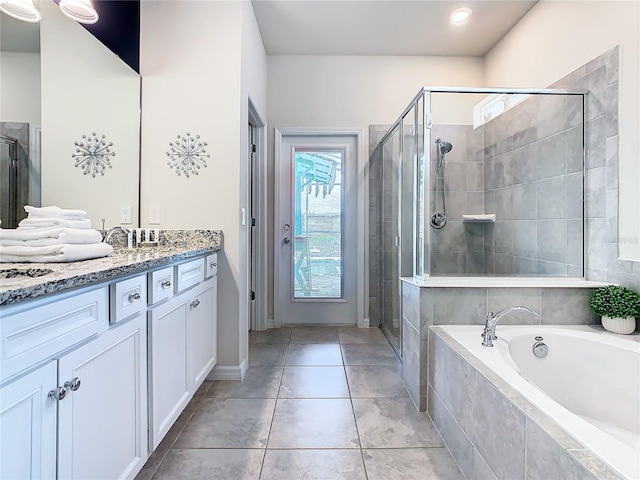 bathroom featuring tile patterned floors, vanity, and independent shower and bath