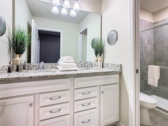 bathroom with vanity, an enclosed shower, and toilet