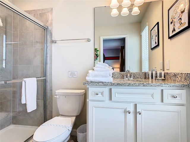 bathroom featuring walk in shower, vanity, toilet, and an inviting chandelier