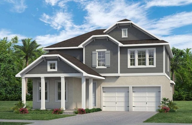 view of front of property with a garage, a porch, and a front yard