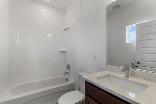 full bathroom with vanity, toilet, and tiled shower / bath combo