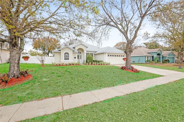 single story home featuring a garage and a front lawn