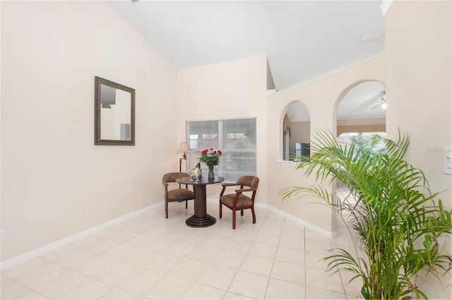 living area featuring crown molding, lofted ceiling, and light tile patterned floors