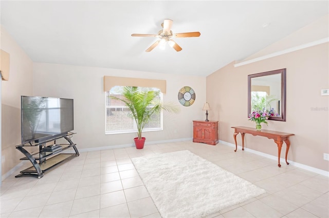 living area featuring vaulted ceiling, light tile patterned floors, and ceiling fan