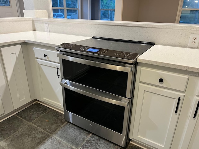 kitchen featuring double oven range and white cabinets