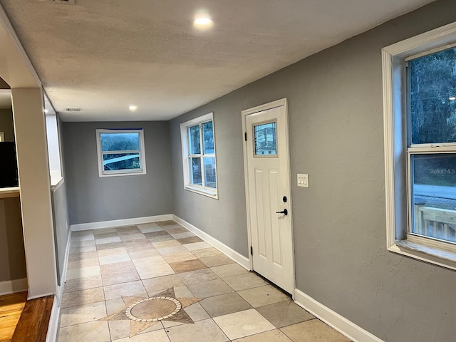 foyer entrance featuring a textured ceiling