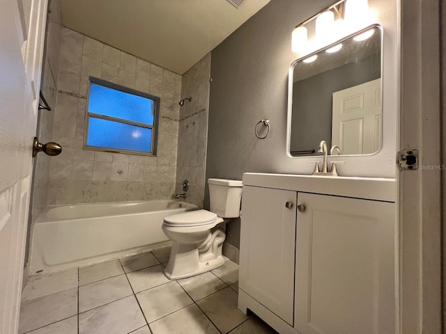 full bathroom featuring tile patterned flooring, vanity, tiled shower / bath, and toilet