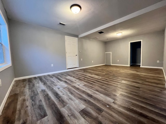 spare room with dark wood-type flooring