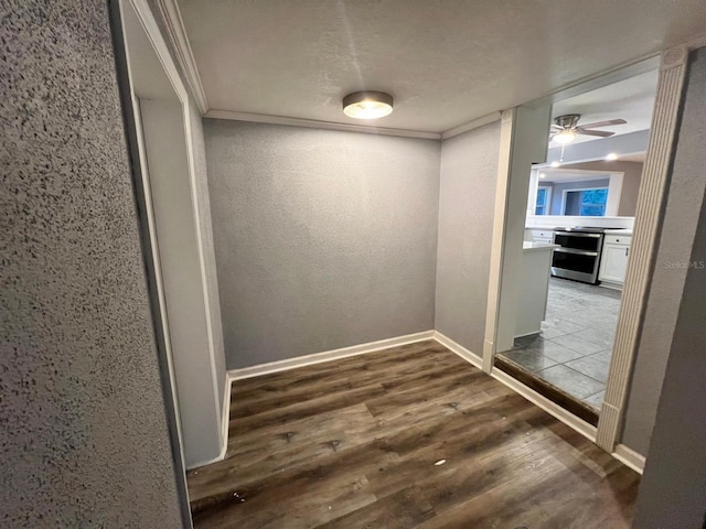 hallway with dark hardwood / wood-style flooring and crown molding