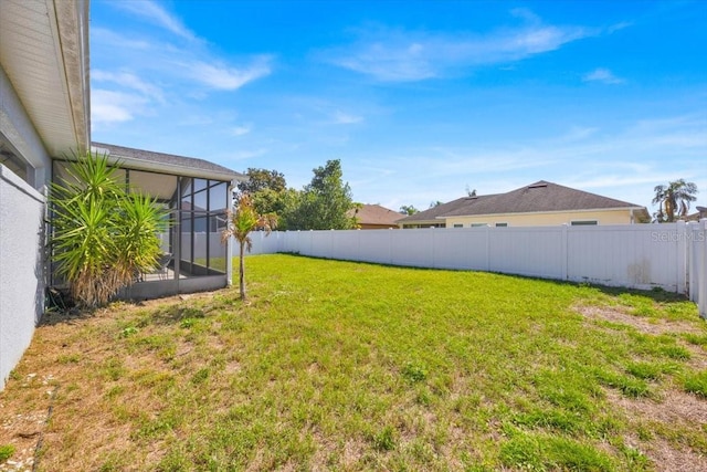 view of yard featuring a fenced backyard and a lanai