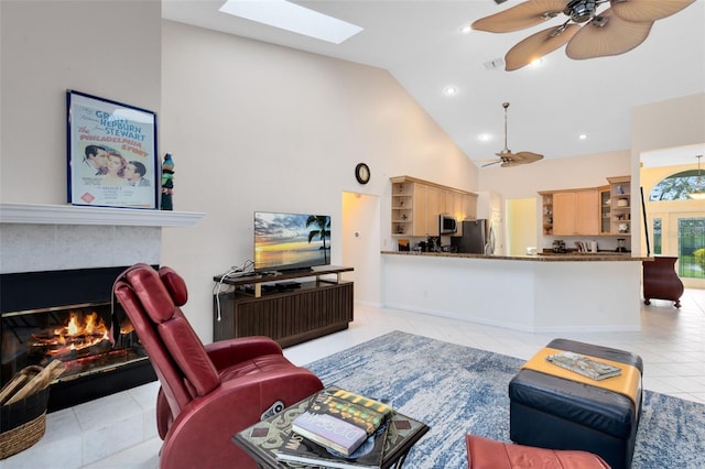 tiled living room featuring a fireplace, high vaulted ceiling, and ceiling fan