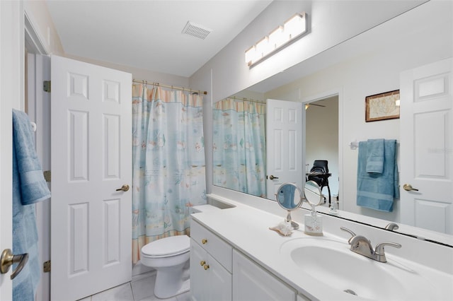 full bathroom featuring tile patterned floors, toilet, vanity, and shower / bath combo