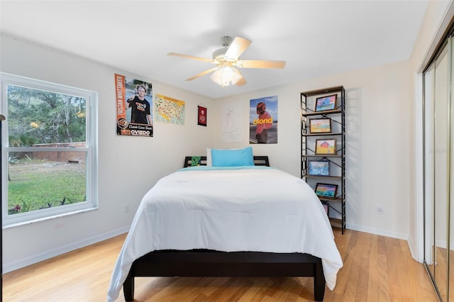 bedroom with a closet, ceiling fan, and light hardwood / wood-style flooring