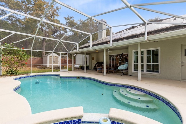 view of pool featuring a shed and a patio area
